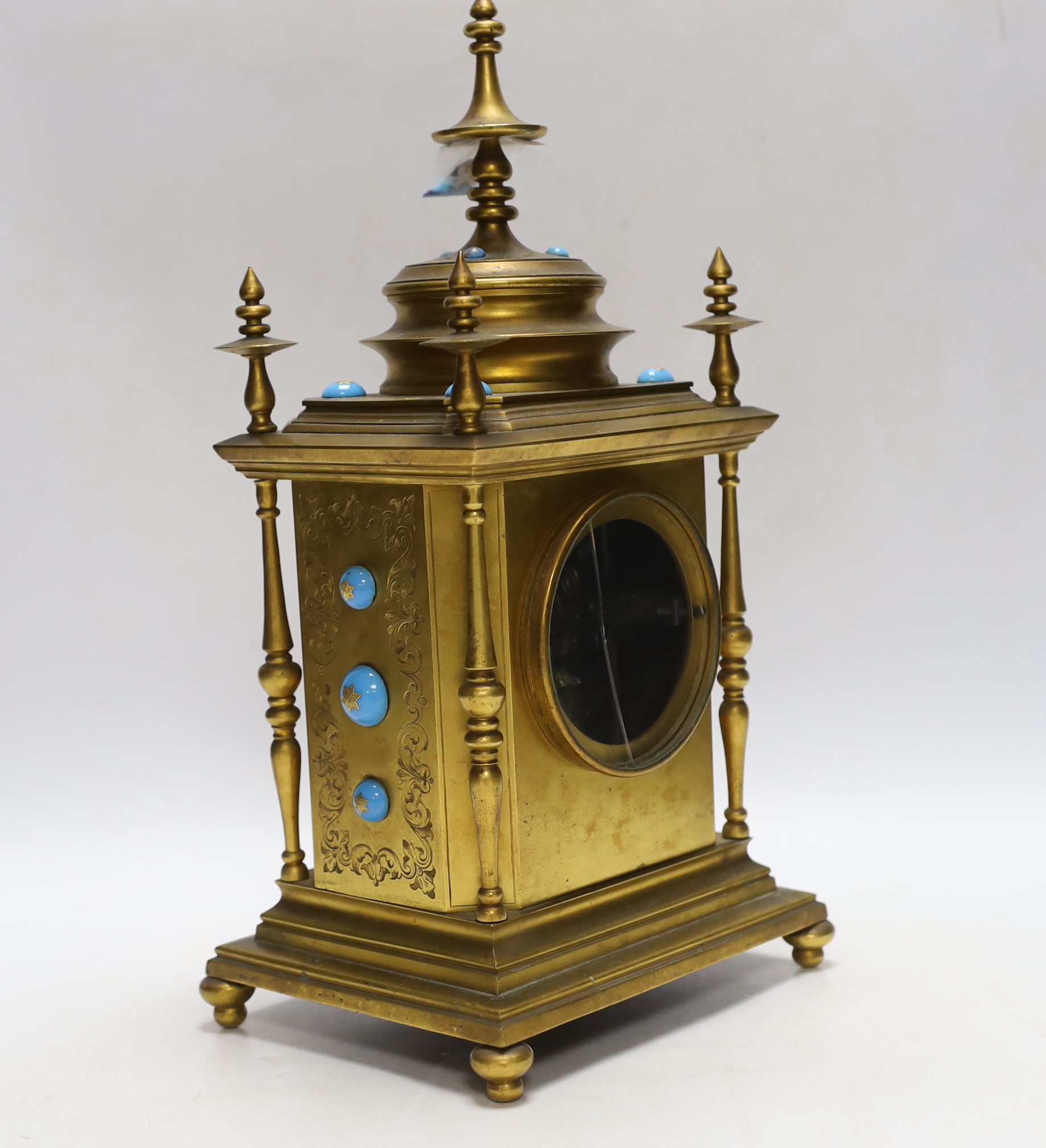 A brass French mantel clock (missing bell and pendulum), 35cm high